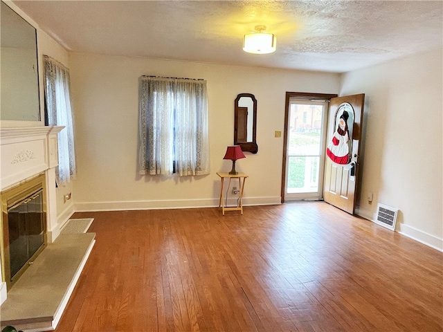 entrance foyer with wood-type flooring and a textured ceiling