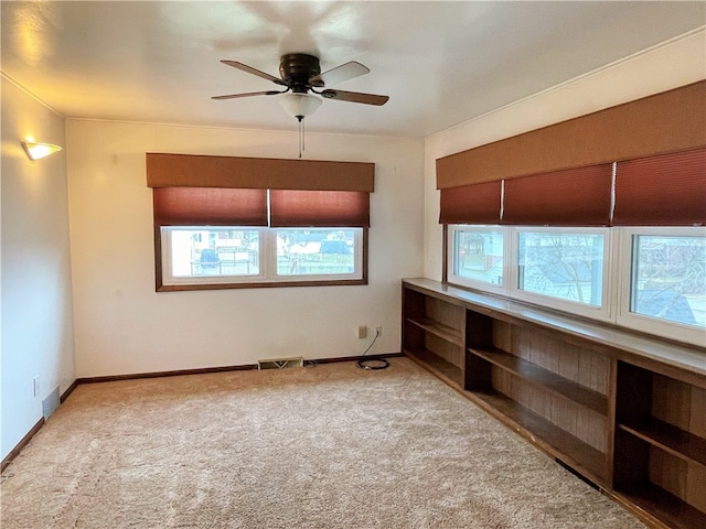 empty room with ceiling fan and light colored carpet