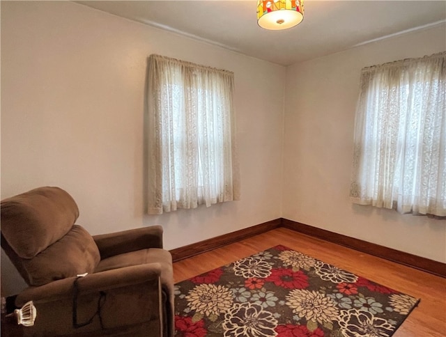 sitting room with hardwood / wood-style flooring