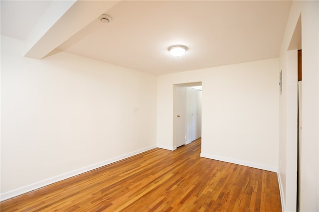 spare room featuring wood-type flooring