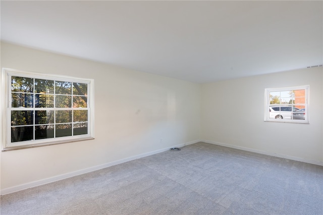 unfurnished room featuring light colored carpet