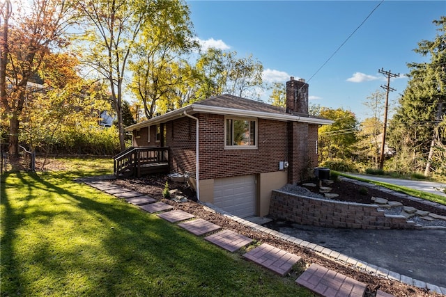 view of home's exterior featuring a yard, a garage, and central air condition unit