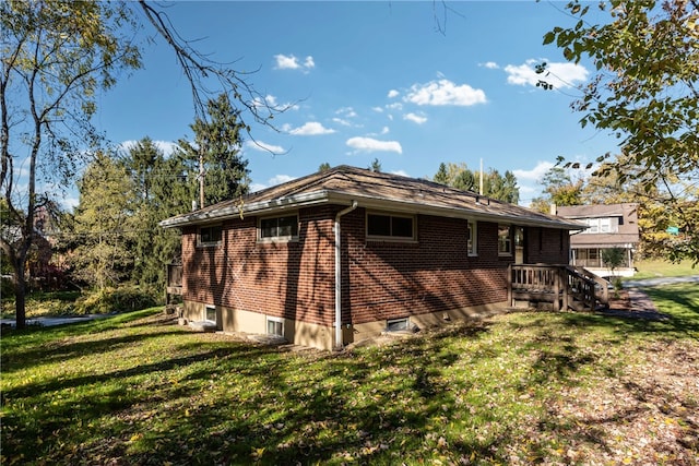 back of property with a wooden deck and a yard