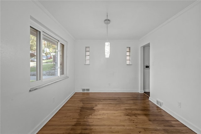 unfurnished dining area with ornamental molding and dark hardwood / wood-style flooring