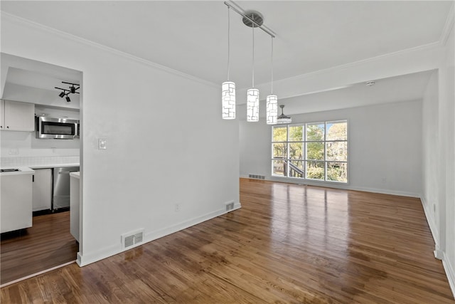 unfurnished dining area featuring crown molding and wood-type flooring