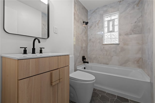 full bathroom with vanity, tiled shower / bath, toilet, and tile patterned floors