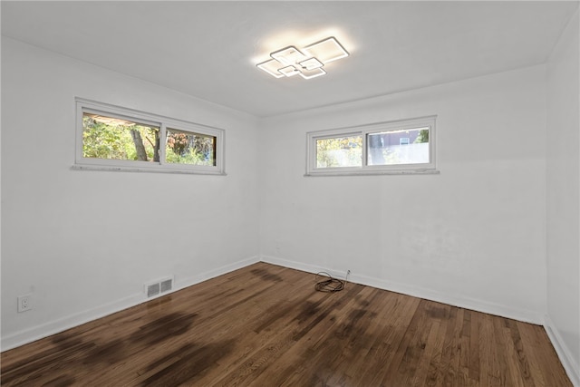 unfurnished room featuring a wealth of natural light and hardwood / wood-style floors