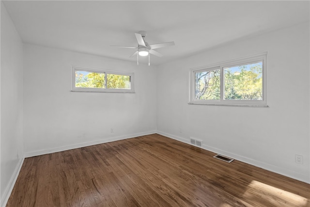 empty room featuring hardwood / wood-style floors, a healthy amount of sunlight, and ceiling fan