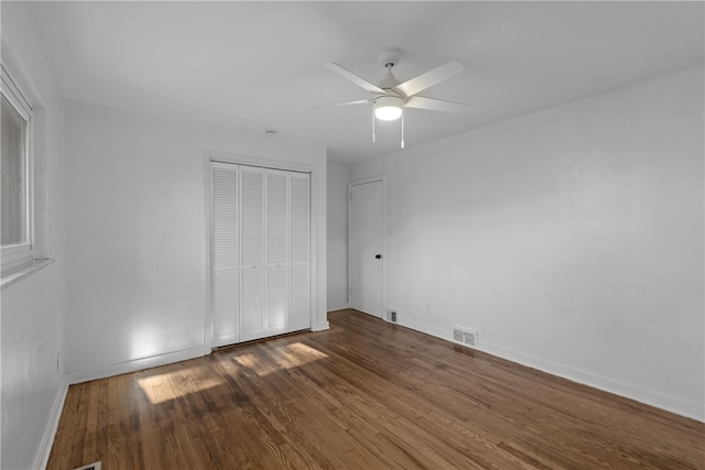 unfurnished bedroom featuring a closet, hardwood / wood-style flooring, and ceiling fan