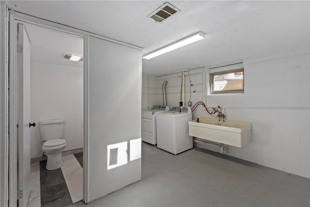 clothes washing area featuring washer and dryer and sink