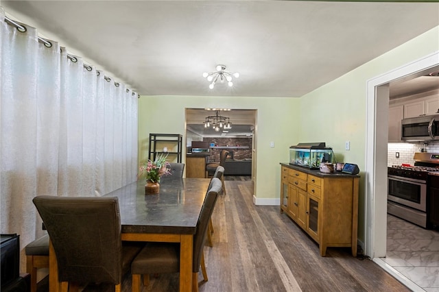 dining room featuring a notable chandelier and dark hardwood / wood-style flooring