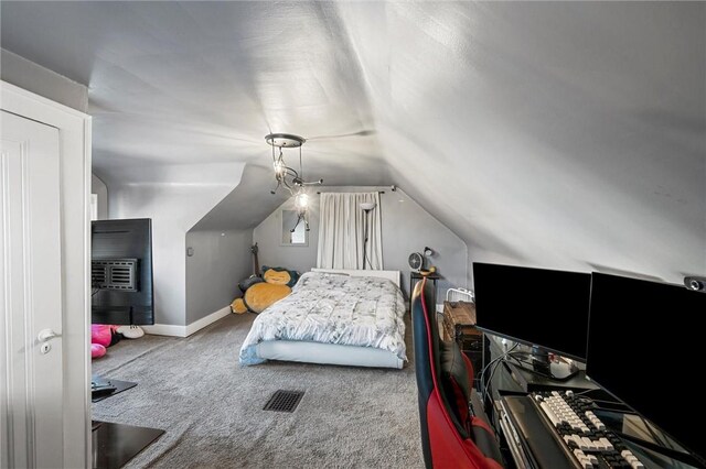 bedroom featuring carpet floors and vaulted ceiling