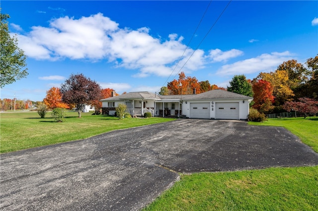 single story home featuring a front yard, a porch, and a garage