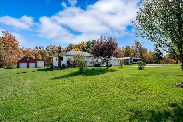 view of yard with an outbuilding and a garage