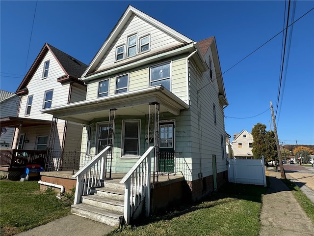 front of property featuring a front lawn and covered porch