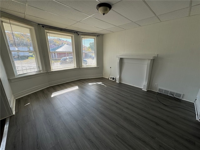 empty room featuring dark hardwood / wood-style floors and a paneled ceiling