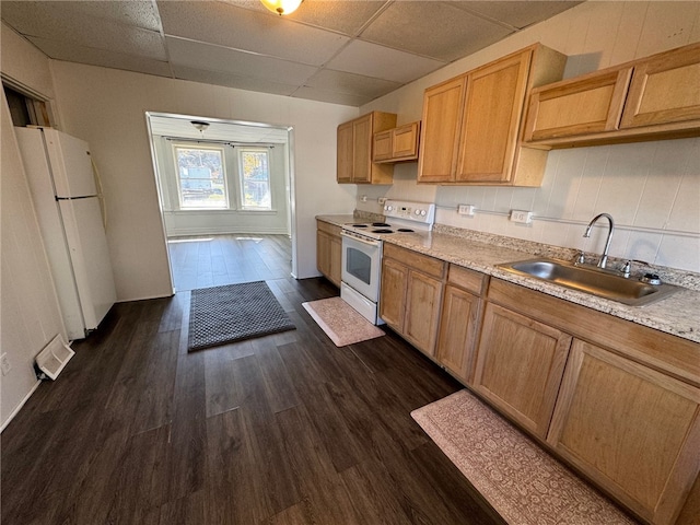 kitchen featuring dark hardwood / wood-style flooring, a drop ceiling, sink, and white appliances