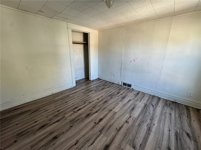 unfurnished bedroom with dark hardwood / wood-style flooring