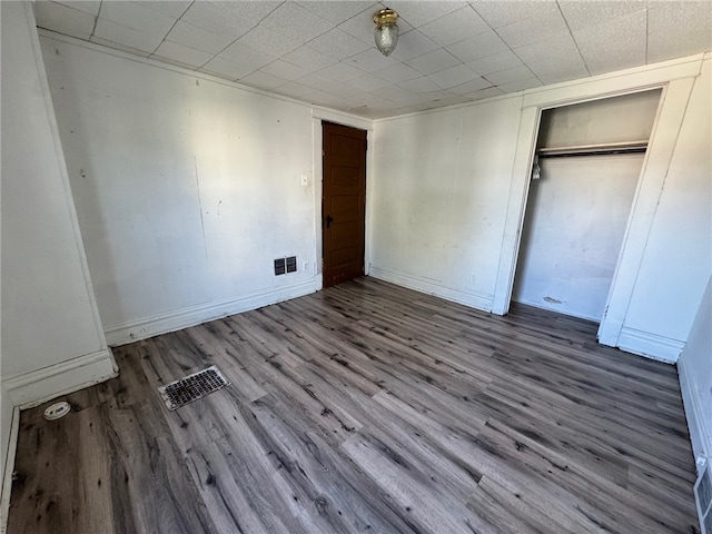 unfurnished bedroom with a closet and wood-type flooring