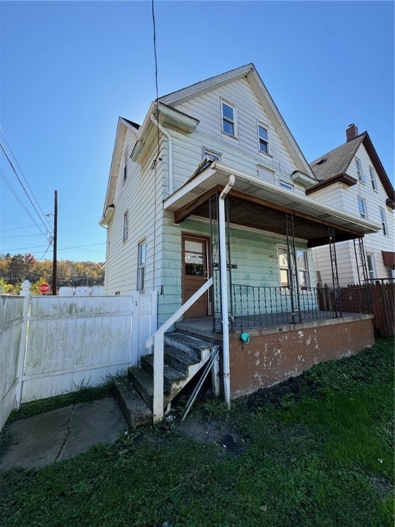 rear view of house featuring a porch