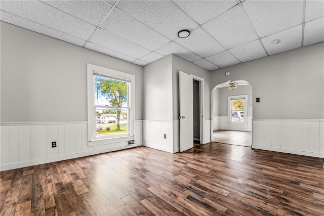 spare room with dark wood-type flooring, a paneled ceiling, and ceiling fan