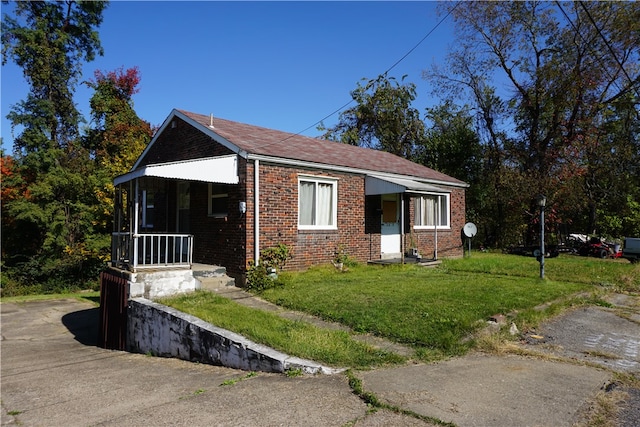 view of home's exterior with a porch and a yard