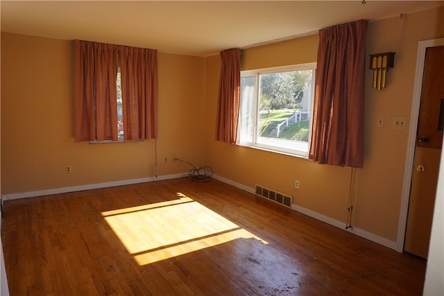 unfurnished room featuring hardwood / wood-style flooring