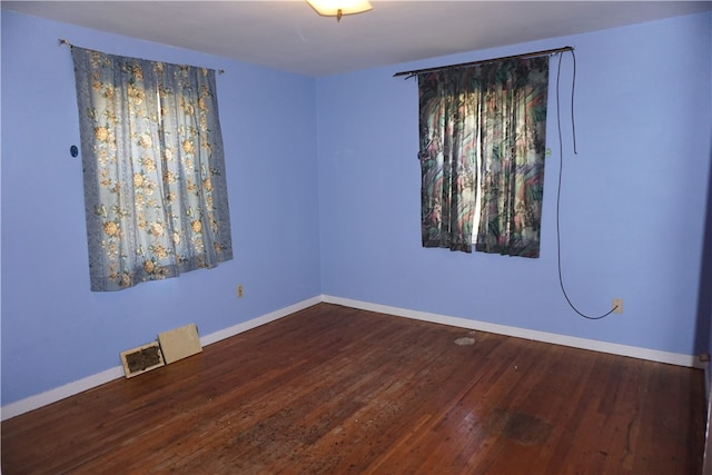 empty room featuring dark hardwood / wood-style flooring