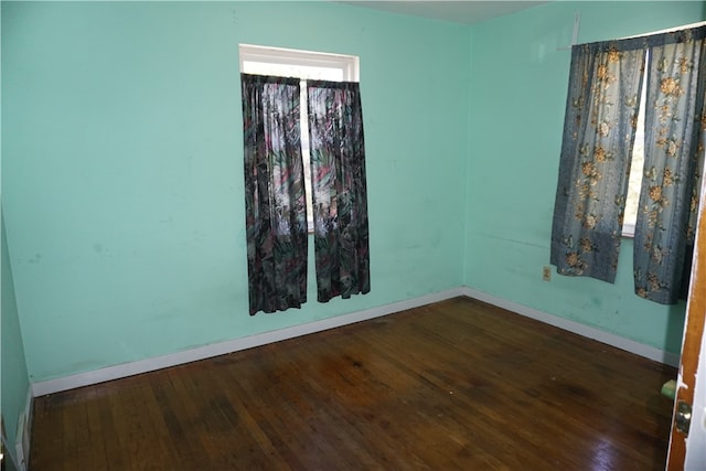 empty room featuring dark wood-type flooring