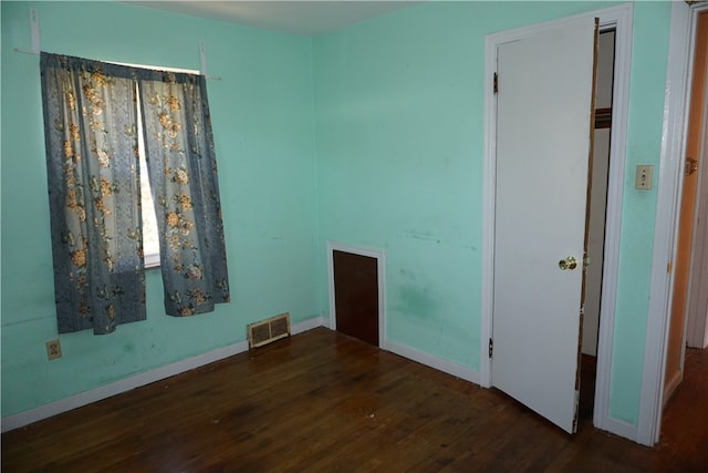 spare room with dark wood-type flooring