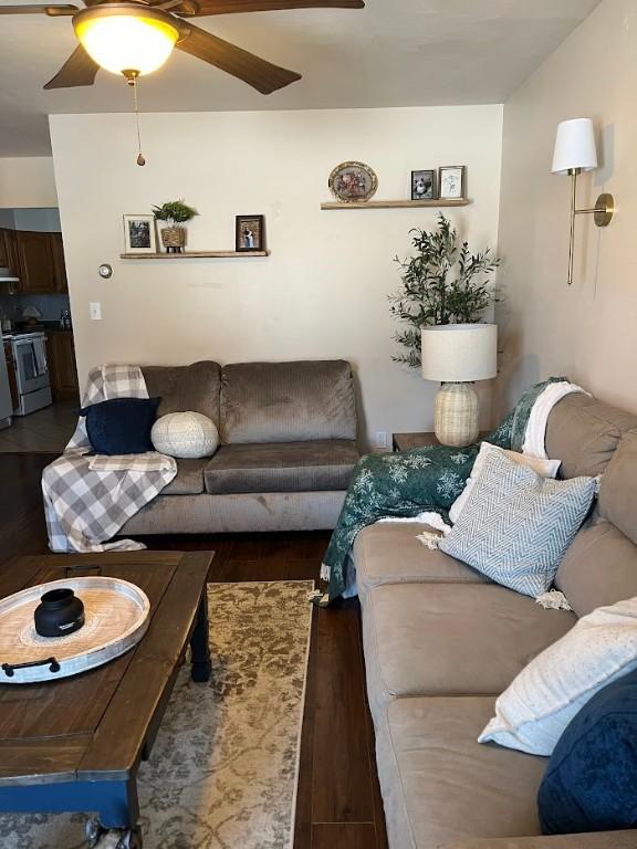 living room featuring dark hardwood / wood-style flooring and ceiling fan