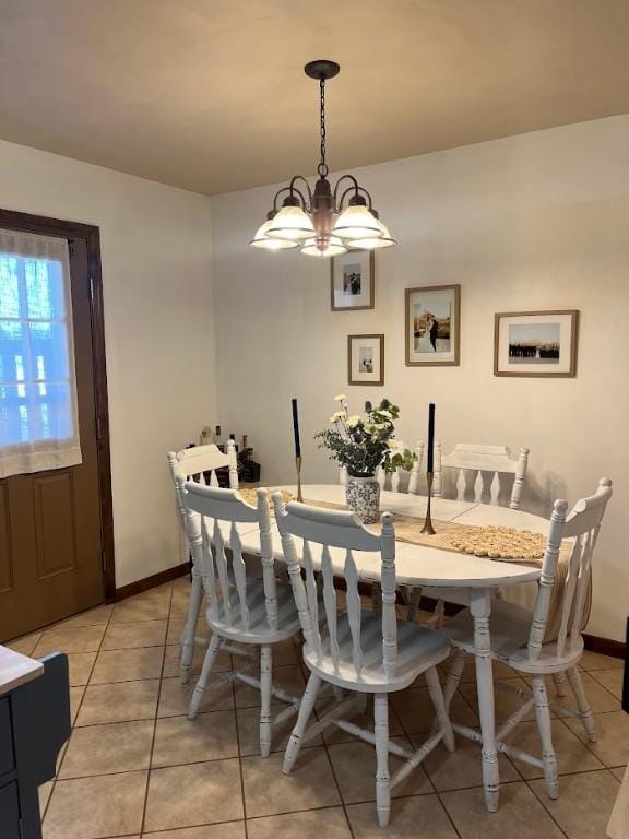 tiled dining area with an inviting chandelier