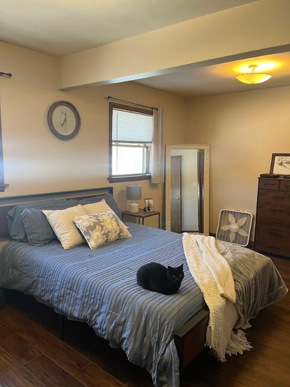 bedroom with dark wood-type flooring