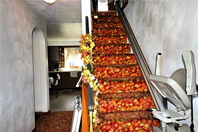 staircase with tile patterned floors