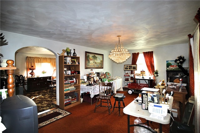 carpeted dining room with a notable chandelier and a healthy amount of sunlight