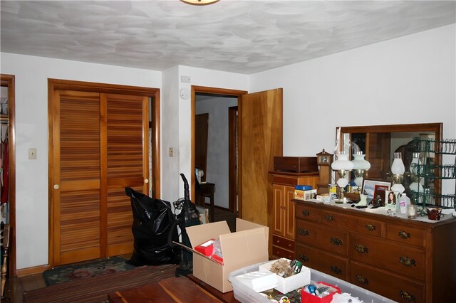 bedroom featuring dark wood-type flooring and a closet