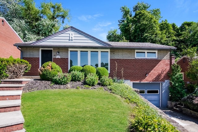 view of front of house with a front yard and a garage