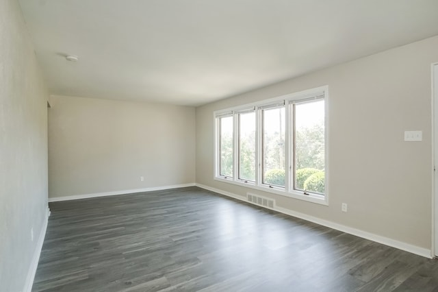 unfurnished room featuring dark hardwood / wood-style floors