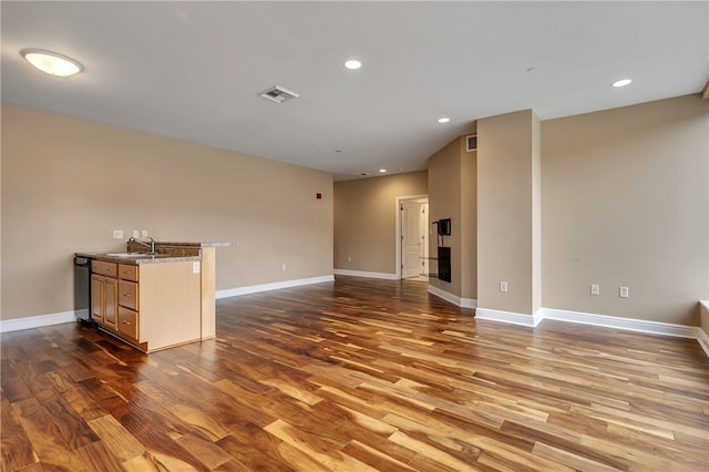 unfurnished living room featuring dark hardwood / wood-style floors and sink