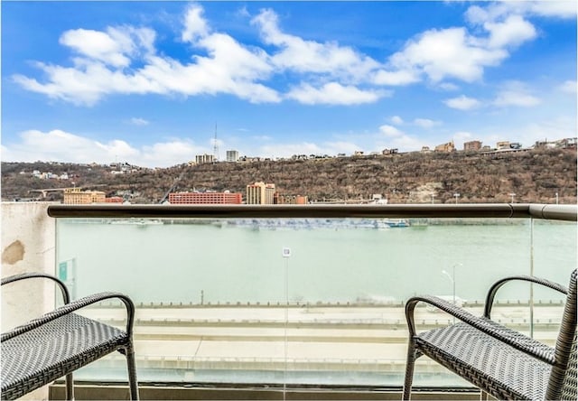 balcony featuring a water view