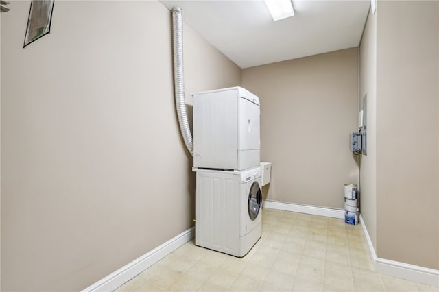 laundry room with stacked washing maching and dryer