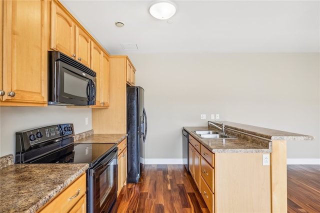 kitchen with light brown cabinetry, black appliances, sink, and dark hardwood / wood-style floors