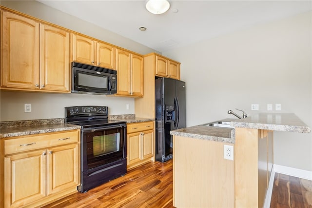 kitchen with dark wood-type flooring, black appliances, sink, and light brown cabinetry