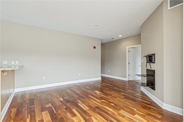 unfurnished living room featuring hardwood / wood-style flooring