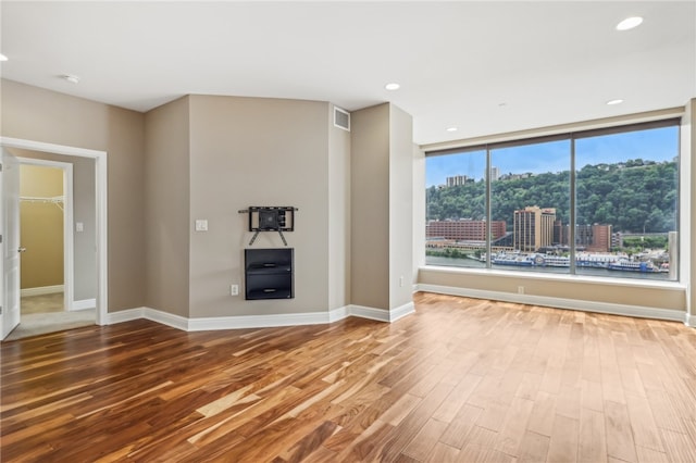 unfurnished living room with wood-type flooring