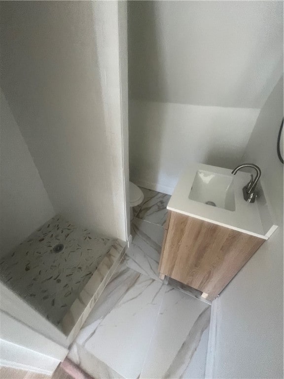 bathroom with lofted ceiling, sink, toilet, and walk in shower