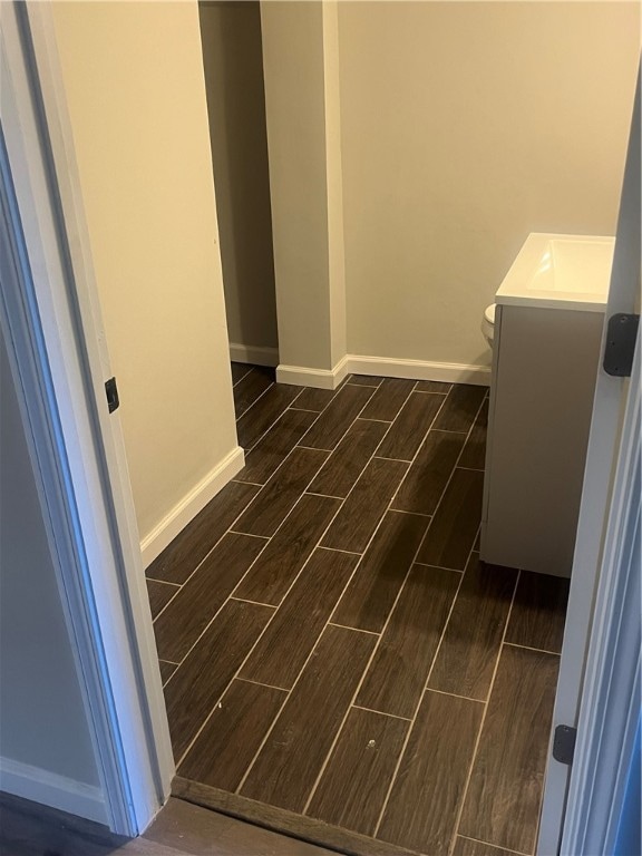 interior space with vanity and wood-type flooring