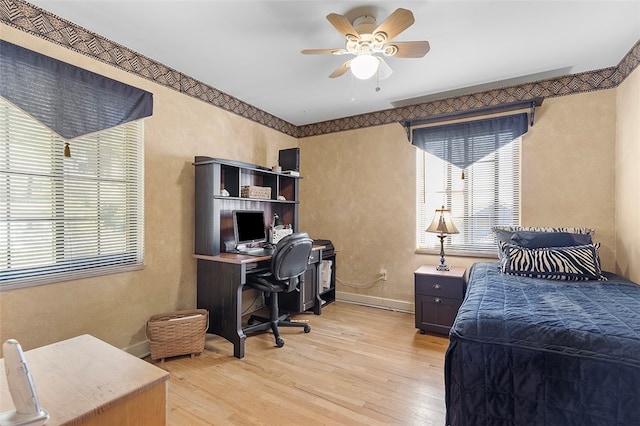 bedroom featuring light hardwood / wood-style floors and ceiling fan