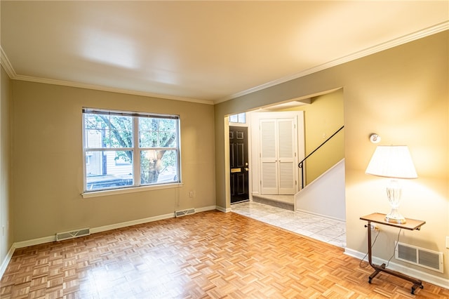 spare room with light parquet floors and ornamental molding