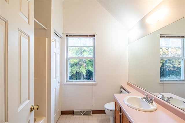 full bathroom featuring vaulted ceiling, toilet, shower / bathtub combination, vanity, and tile patterned flooring